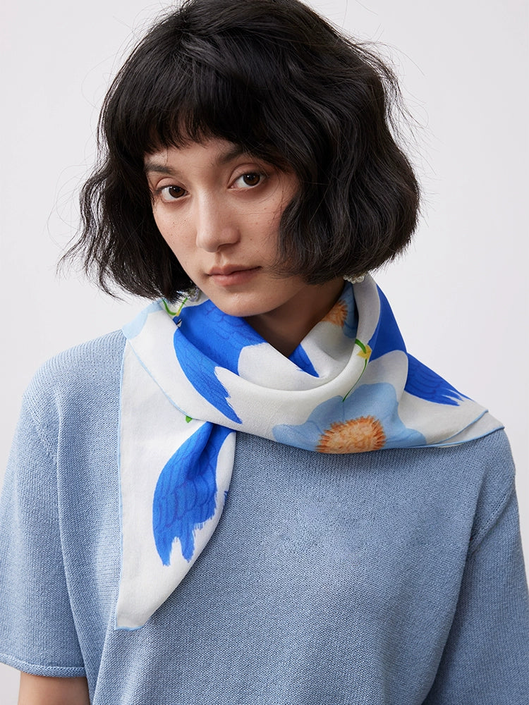 A luxurious silk scarf made from 100% mulberry silk, showcasing a glossy finish and elegant drape, perfect for timeless style.