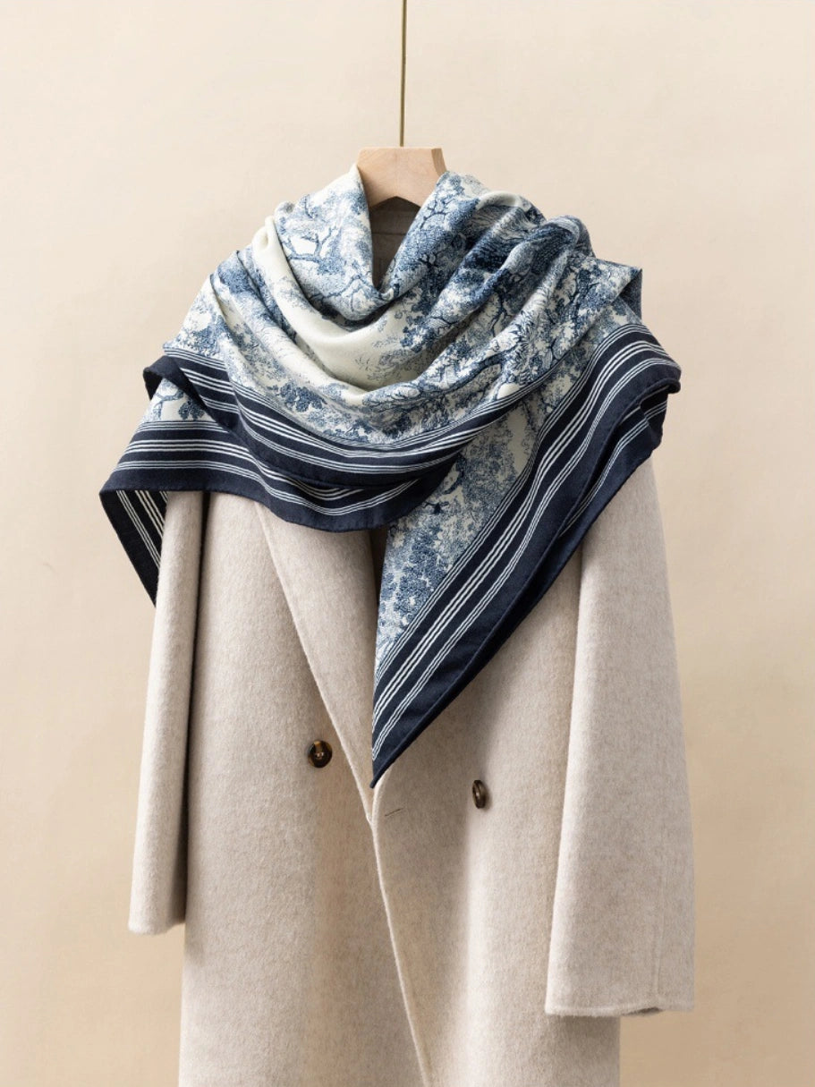 Silk Wool Square Scarf - Animal Jungle Print | Blue, 130*130cm, draped on a coat, showcasing vibrant jungle pattern, stylish and luxurious accessory. 