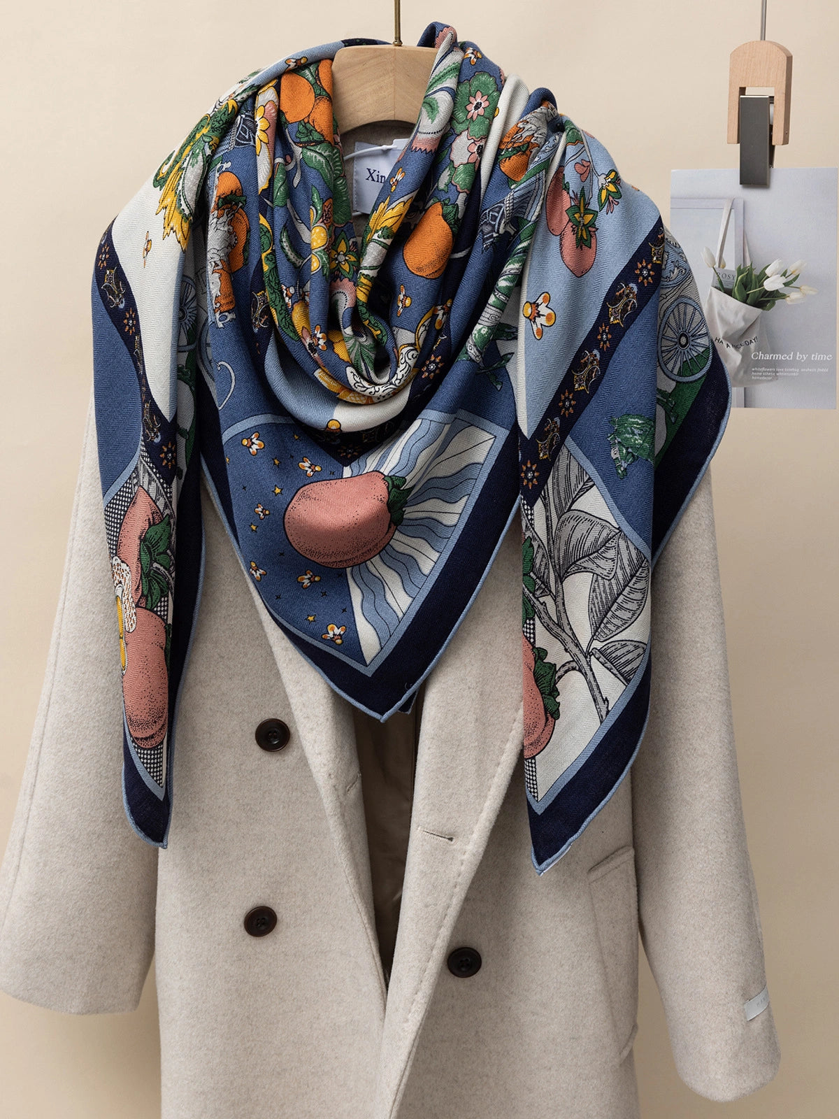 Silk wool scarf - Persimmon print | Blue, 130*130 cm, draped over a coat, showcasing various styling options.