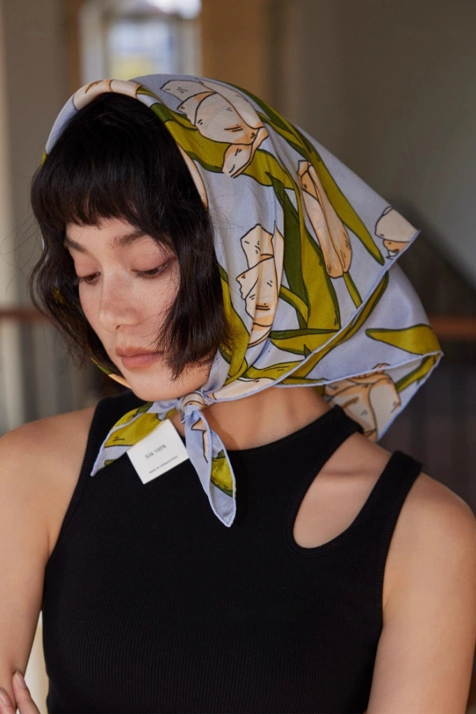 A blue tulip floral printed silk square scarf made from 100% mulberry silk, shown as the front of a headscarf.