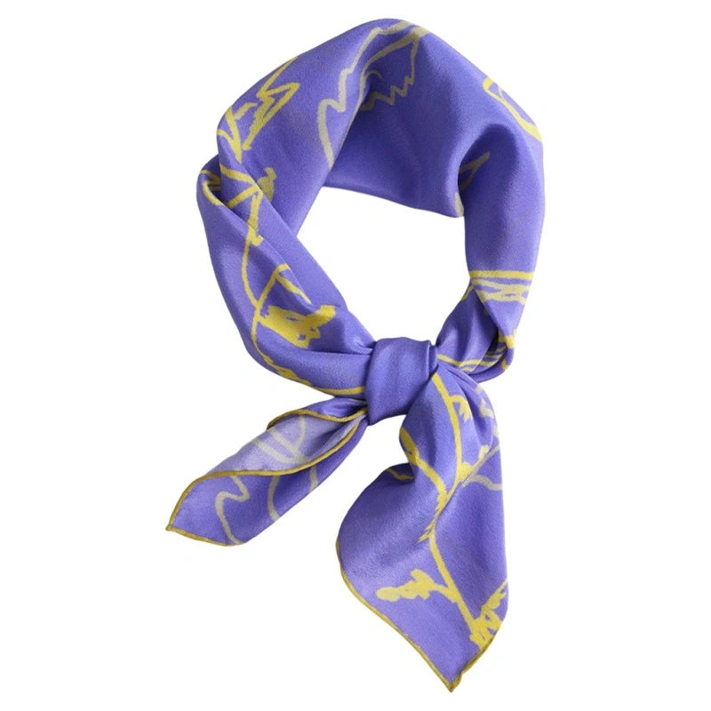 Blue silk square scarf (63x63cm) with yellow botanical print, tied in a knot, showcasing mulberry silk elegance.