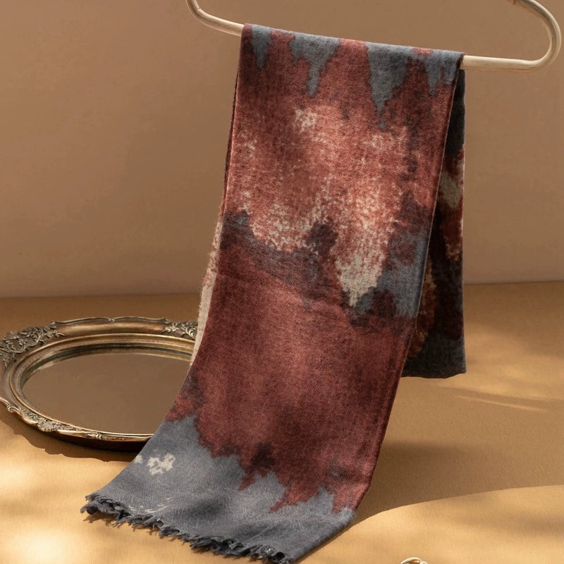 Burgundy cashmere scarf draped elegantly, emphasizing its lightweight and oversized dimensions.