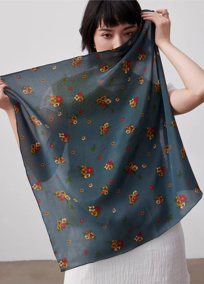 Greenish-blue floral silk square scarf, 100% mulberry silk, displayed flat to highlight its elegant floral design.