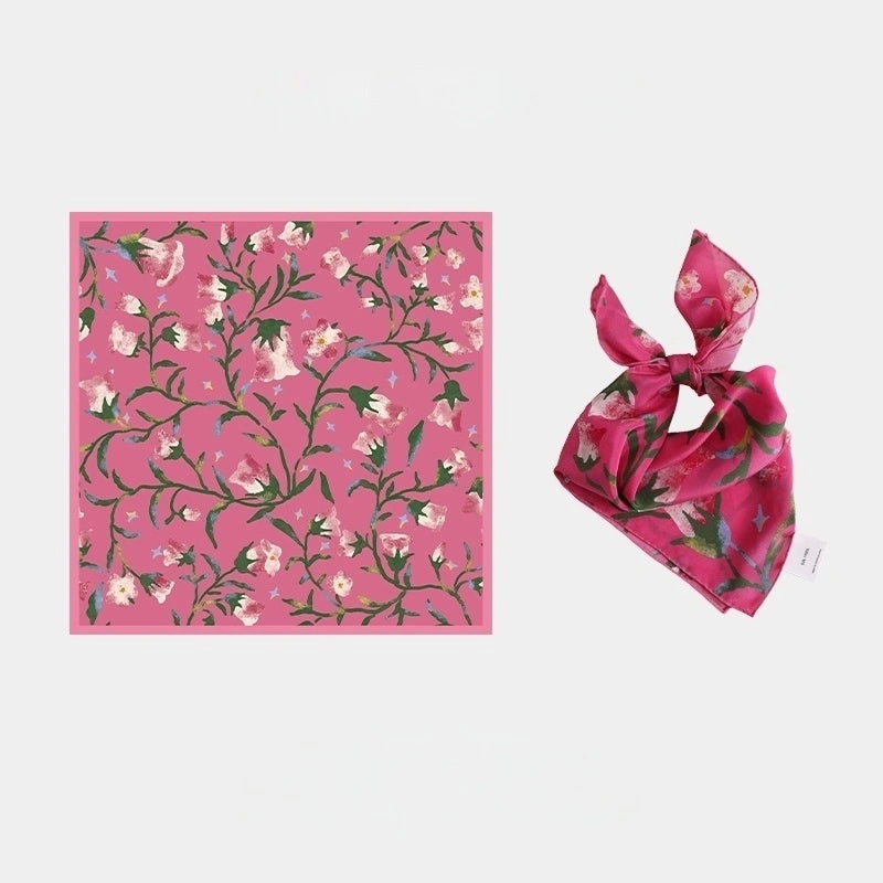 Berry Powder silk square scarf (63x63cm) laid flat, showcasing its vibrant pink morning glory floral pattern on mulberry silk.