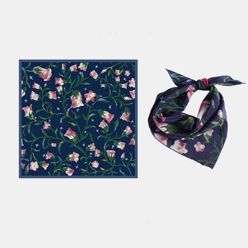 Close-up of Midnight Blue silk scarf, showcasing the intricate morning glory floral pattern and luxurious texture.