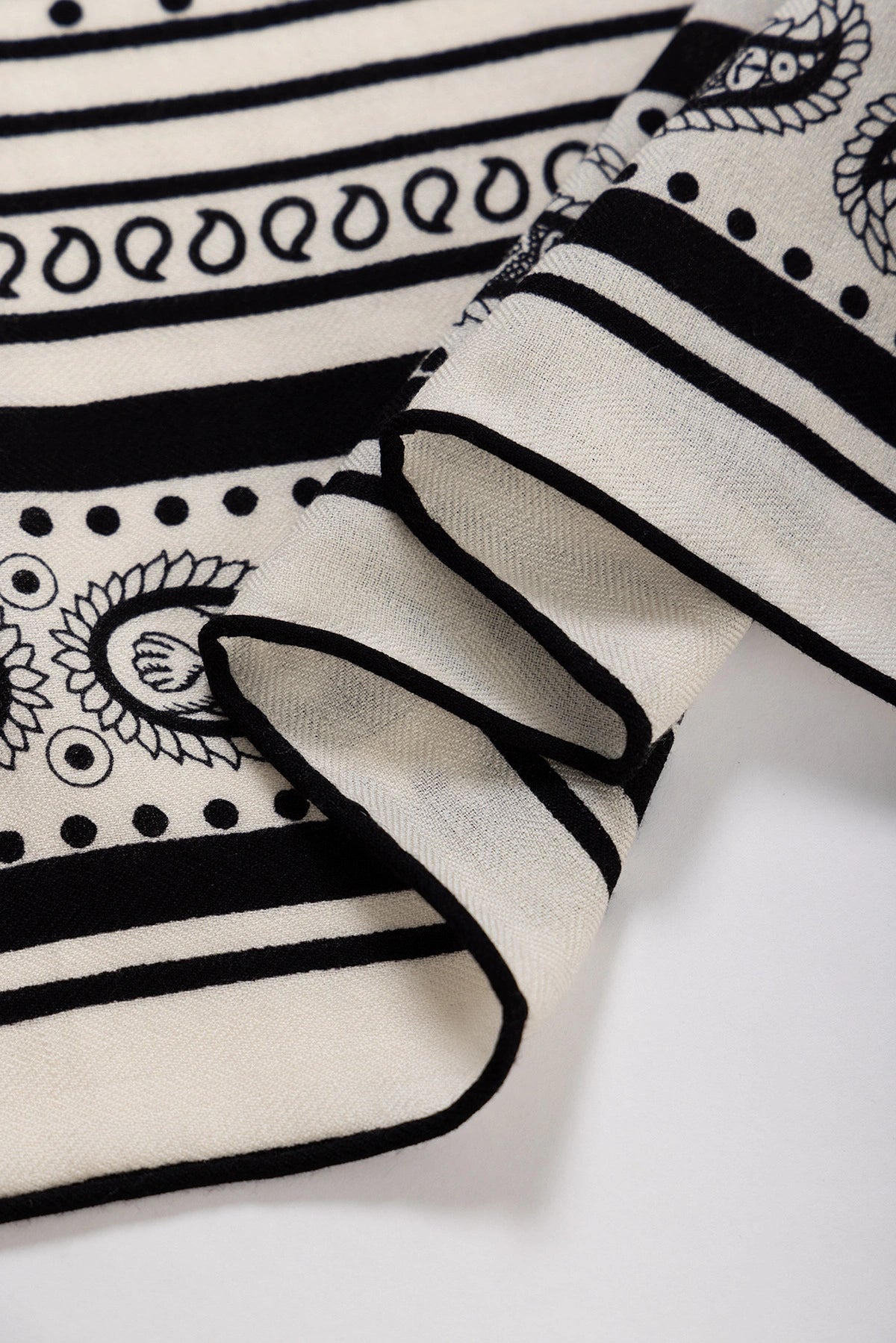 Close-up of Silk Wool Square Scarf - Nautical Fantasy Print | Off-White,highlighting red paisley edge and beige fabric.