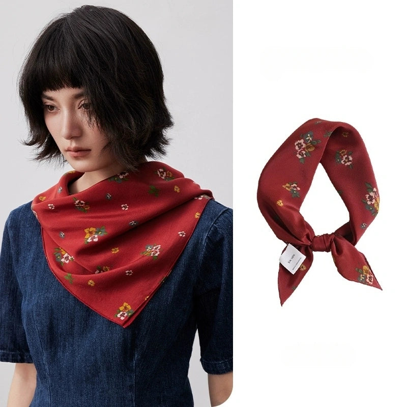 Close-up of red floral silk square scarf made of 100% mulberry silk, showing its delicate floral pattern and luxurious texture.