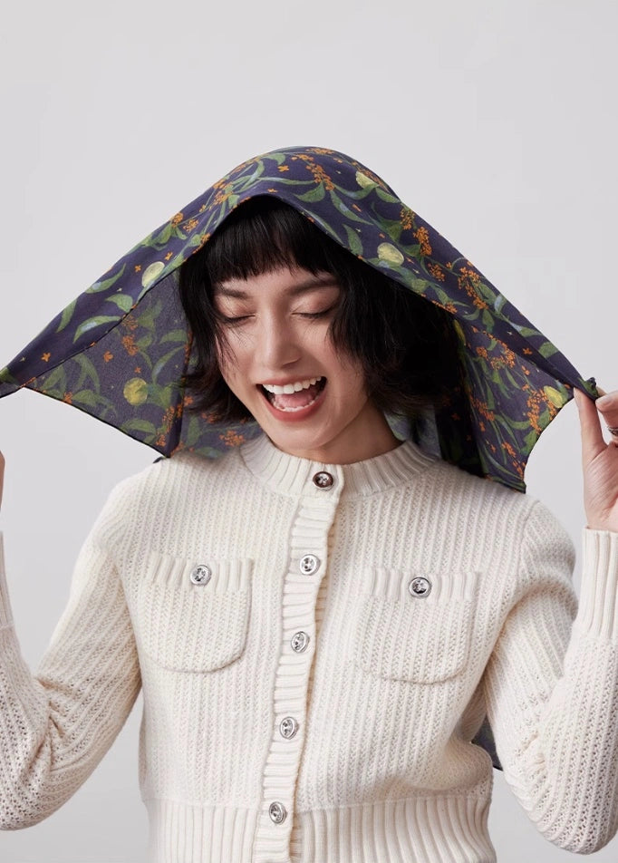 Dark blue osmanthus silk scarf styled as a chic headscarf, showcasing its lightweight and breathable material.