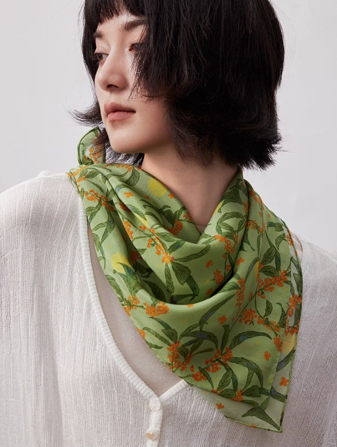 Green osmanthus silk square scarf styled as a neck accessory, demonstrating its elegance and versatility.